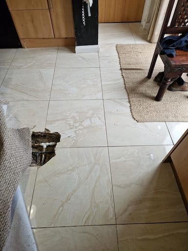 Leaking copper pipe under floor tiles