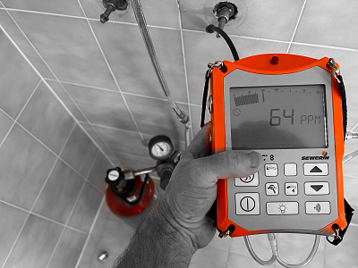 A specialised gas detector being used to locate a gas leak